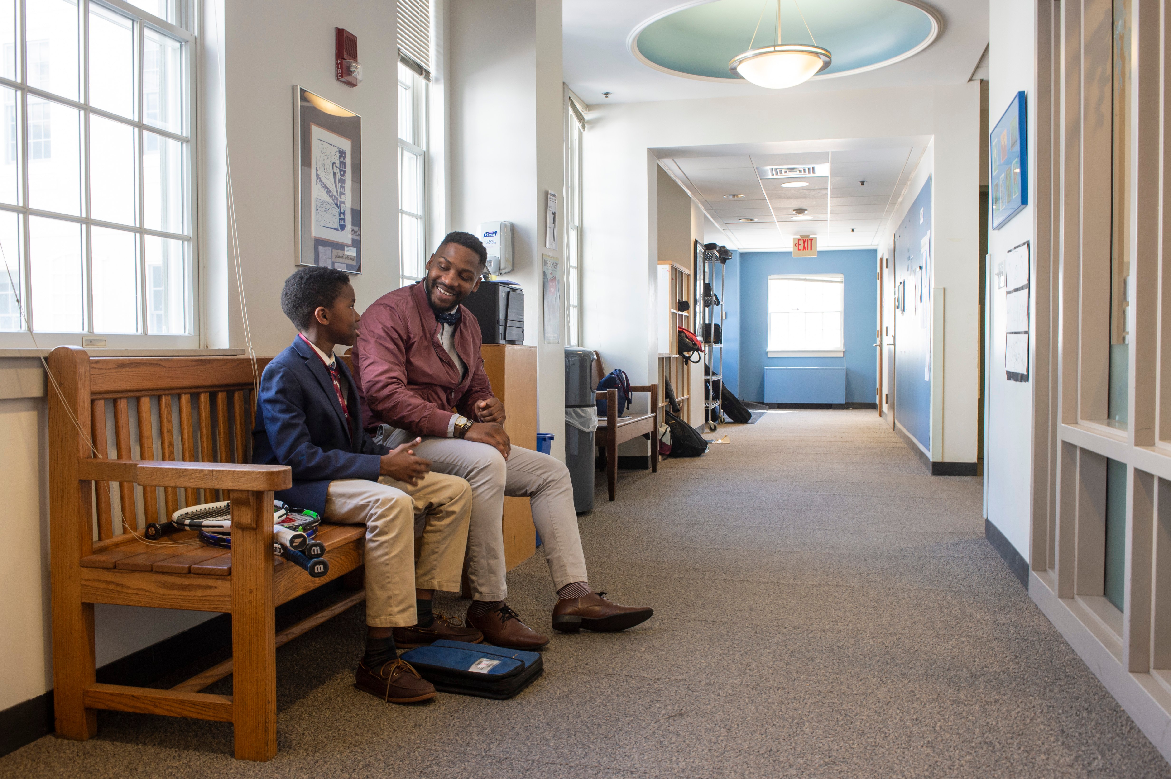 a father and his son waiting to join an admissions interview at The Fessenden School.