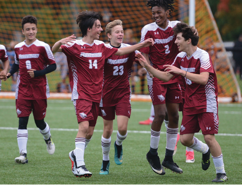  Soccer players at The Fessenden School celebrating a goal.