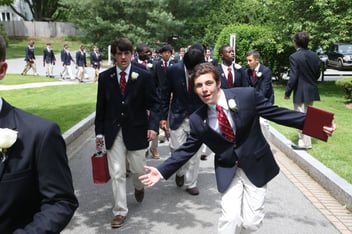  Students at The Fessenden School walking in a line on campus after school mass.