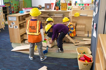 Kindergarten students dressed up as construction workers while they’re building something in their classroom at a private school in MA.