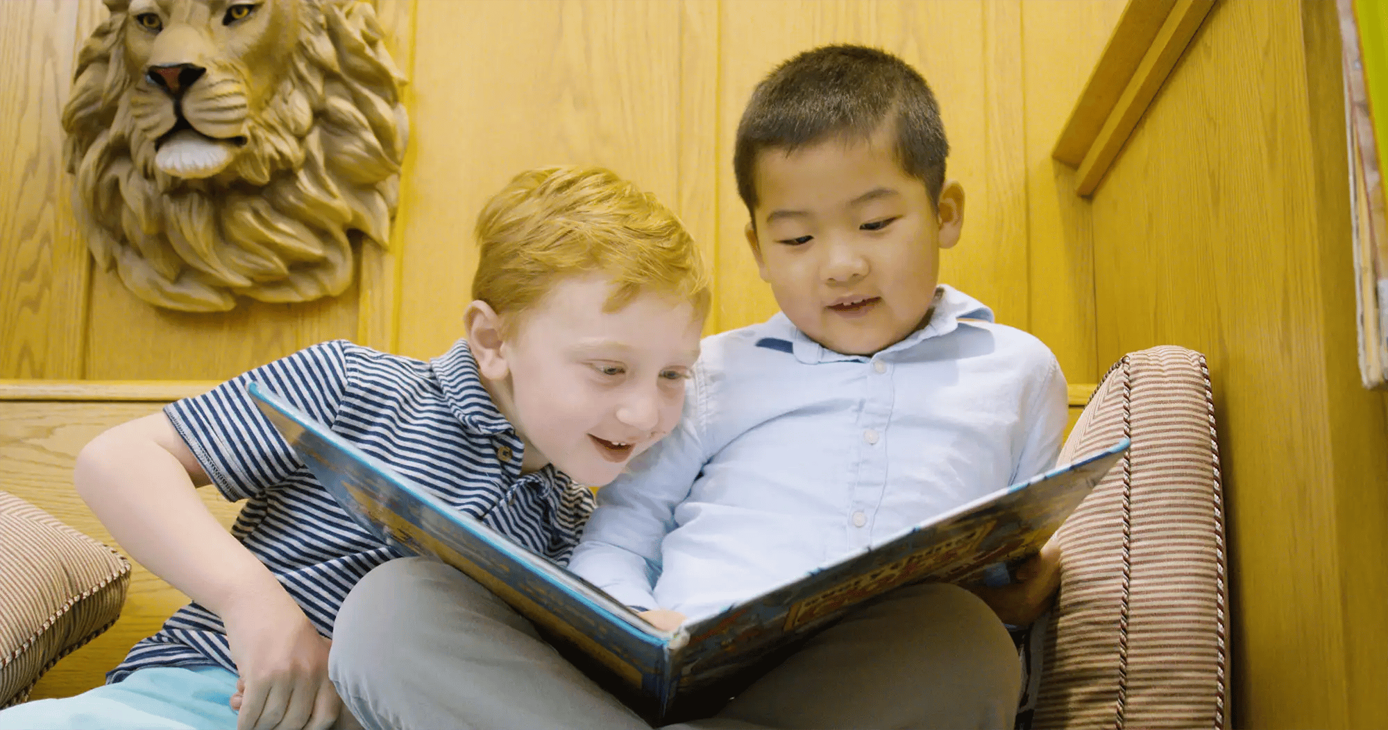 Boys reading together in the library